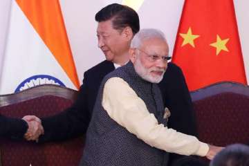 In this Oct. 16, 2016, file photo, Prime Minister Narendra Modi, front and Chinese President Xi Jinping shake hands with leaders at the BRICS summit in Goa, India. 
 