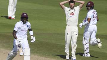 England's Mark Wood, center, reacts as West Indies' Jermaine Blackwood, left, and Shane Dowrich run between the wickets to score during the fifth day of the first cricket Test match between England and West Indies, at the Ageas Bowl in Southampton, England, Sunday, July 12