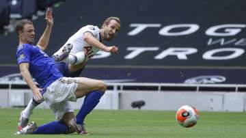 Tottenham's Harry Kane, 2nd left, scores his side's second goal during the English Premier League soccer match between Tottenham Hotspur and Leicester City, at the Tottenham Hotspur Stadium in London, Sunday, July 19