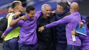 Tottenham's manager Jose Mourinho, center, celebrates at the end of the English Premier League soccer match between Crystal Palace and Tottenham at the Selhurst Park stadium in London, Sunday, July 26