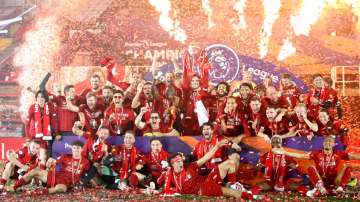 Liverpool players receive Premier League trophy on Kop