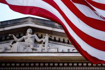 In this March 22, 2019 file photo, an American flag flies outside the Department of Justice in Washi