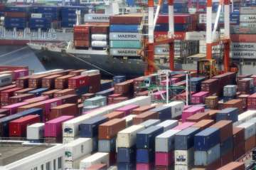 In this June 17, 2020, file photo, containers are piled up at a port in Yokohama, south of Tokyo. Ja