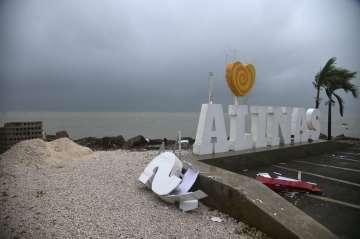 Remnants of a city sign lay on the beach damaged by Tropical Storm Laura in Salinas, Puerto Rico, Sa