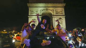 Supporters of the Paris Saint Germain soccer team celebrates on the Champs Elysee in Paris, Tuesday, Aug. 18, 2020 after his team won 3-0 against RB Leipzig
