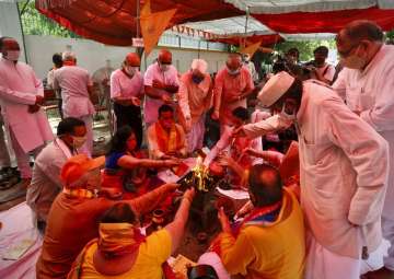 Hindus offer prayers for a groundbreaking ceremony of a temple dedicated to the Hindu god Ram in Ayodhya, at the Vishwa Hindu Parishad, or World Hindu Council, headquarters in New Delhi, India, Wednesday, Aug. 5, 2020. The coronavirus is restricting a large crowd, but Hindus were joyful before Prime Minister Narendra Modi breaks ground Wednesday on a long-awaited temple of their most revered god Ram at the site of a demolished 16th century mosque in northern India. 