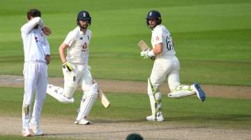 Jos Buttler and Chris Woakes of England run watched on by Shaheen Afridi of Pakistan during Day Four of the 1st #RaiseTheBat Test Match between England and Pakistan at Emirates Old Trafford on August 08