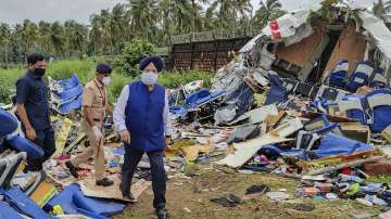 Union Civil Aviation Minister Hardeep Singh Puri inspects the crash site of an Air India Express fli