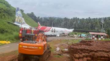 Kozhikode: Mangled remains of an Air India Express flight, en route from Dubai, after it skidded off the runway while landing on Friday night, at Karippur in Kozhikode, Saturday, Aug. 8, 2020. (PTI Photo)
