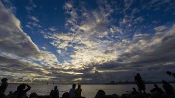 People gather at sea-side in Mumbai for a moment to relax. In the backdrop is the Bandra-Worli sea l