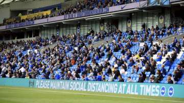 Brighton soccer fans adhere to social distancing measures in the stands as they watch the action on the pitch during the pre-season friendly between Brighton and Chelsea, at the AMEX Stadium in Brighton, England, Saturday, Aug. 29