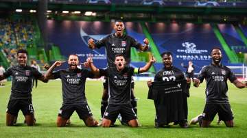 Lyon players celebrate after winning the Champions League quarterfinal match against Manchester City at the Jose Alvalade stadium in Lisbon, Portugal, Saturday, Aug. 15