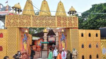 People move past the Ram Janmabhoomi Nyas workshop, ahead of the ground breaking ceremony of the Ram