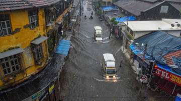 Mumbai: Vehicles ply on a waterlogged street during heavy rains, at Byculla area in Mumbai, Wednesda