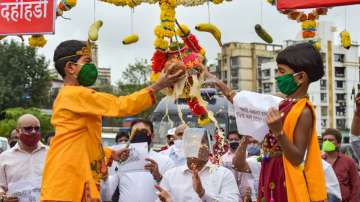 Youngsters dressed as Lord Krishna break an earthen pot on the occasion of Janmashtami (Dahi Handi),