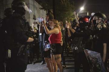 Protesters standoff with police as they take to the streets Friday, Sept. 4, 2020 in Portland, Ore. 