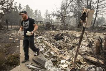  Derek Trenton from Talent, Ore. salvages some items at his parents home as wildfires devastate the 