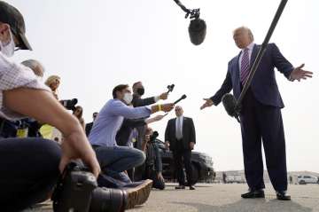 President Donald Trump speaks to reporters as he arrives at Sacramento McClellan Airport, in McClell