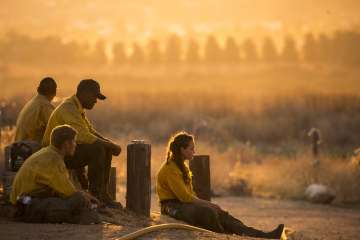 Firefighters rest during a wildfire in Yucaipa, Calif., Saturday, Sept. 5, 2020. Firefighters trying