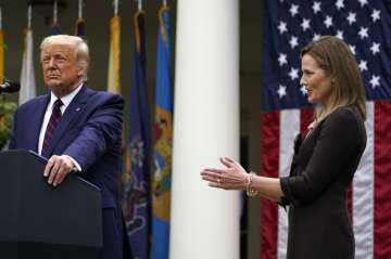  Judge Amy Coney Barrett applauds as President Donald Trump announces Barrett as his nominee to the 