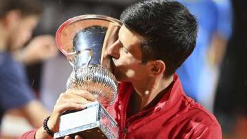 Serbia's Novak Đjoković kisses his trophy after winning his match with Argentina's Diego Sebastián Schwartzman during their final match at the Italian Open tennis tournament, in Rome, Monday, Sept. 21
