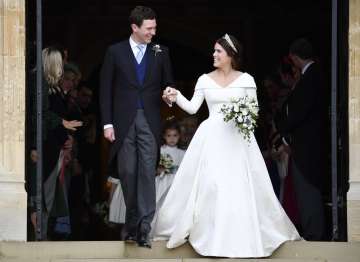 Britain's Princess Eugenie and Jack Brooksbank leave St George's Chapel after their wedding at Winds