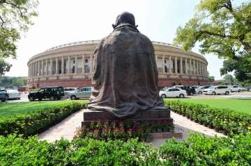 Opposition members sit in protest against farm bill inside Rajya Sabha