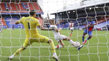 Crystal Palace's Wilfried Zaha, right, scores his side's opening goal during the English Premier League soccer match between Crystal Palace and Southampton, at Selhurst Park, London, Saturday, Sept. 12