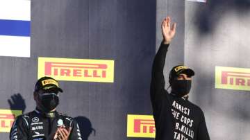 Winner of the race, Mercedes driver Lewis Hamilton of Britain, right, waves as he stands with second place Mercedes driver Valtteri Bottas of Finland on the podium during the Formula One Grand Prix of Tuscany, at the Mugello circuit in Scarperia, Italy, Sunday, Sept. 13