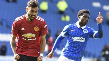 Manchester United's Bruno Fernandes celebrates after he scores his sides third goal from the penalty spot during the English Premier League soccer match between Brighton Hove Albion and Manchester United in Brighton, England, Saturday, Sept. 26