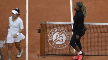 Serena Williams of the U.S. walks to her bench after defeating Kristie Ahn of the U.S., left, in the first round match of the French Open tennis tournament at the Roland Garros stadium in Paris, France, Monday, Sept. 28