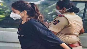 Rhea Chakraborty waves to cameras as she gets arrested 
