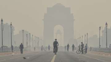 A cyclist rides near India Gate amid hazy weather conditions in New Delhi on Monday. 
