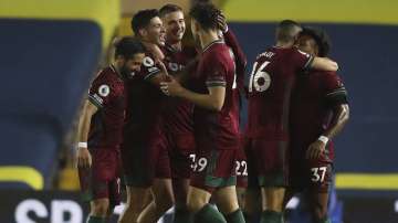 Wolverhampton Wanderers' Raul Jimenez, 2nd left, celebrates with his teammates after scoring during the English Premier League soccer match between Leeds United and Wolverhampton Wanderers at Elland Road ground in Leeds, England, Monday, Oct. 19