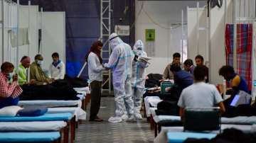 A team of doctors check patients at CWG village COVID-19 Care Centre, near Akshardham in New Delhi. 