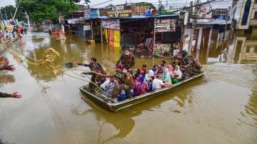 Rescue operation being carried out for locals to move them to safer places following heavy rain, at 