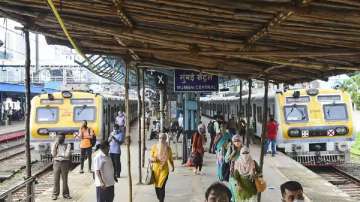 Commuters are seen on a platform at a station after local train services were disrupted due to power outage in Mumbai.