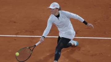 Poland's Iga Swiatek plays a shot against Italy's Martina Trevisan in the quarterfinal match of the French Open tennis tournament at the Roland Garros stadium in Paris, France, Tuesday, Oct. 6