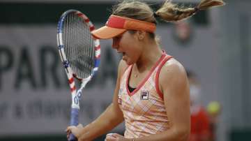 Sofia Kenin of the U.S. clenches her fist after scoring a point against Petra Kvitova of the Czech Republic in the last game of the semifinal match of the French Open tennis tournament at the Roland Garros stadium in Paris, France, Thursday, Oct. 8
