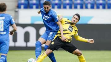 Hoffenheim's Ishak Belfodil, left, and Dortmund's Mats Hummels challenge for the ball during the German soccer Bundesliga match between TSG Hoffenheim and Borussia Dortmund in Sinsheim, Germany, Saturday, Oct. 17