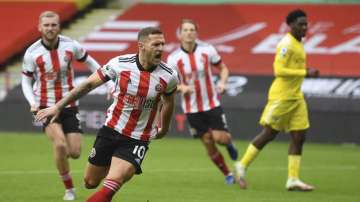 Sheffield United's Billy Sharp celebrates after scoring his side's opening goal from the penalty spot during the English Premier League soccer match between Sheffield United and Fulham at Bramall Lane stadium in Sheffield, England, Sunday, Oct. 18
