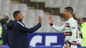 In this Sunday, Oct. 11, 2020 file photo France's Kylian Mbappe and Portugal's Cristiano Ronaldo, right, greet each other before the UEFA Nations League soccer match between France and Portugal at the Stade de France in Saint-Denis, north of Paris, France