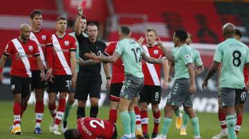 Everton's Lucas Digne, centre, is shown a red card by the referee after a foul on Southampton's Kyle Walker-Peters during an English Premier League soccer match between Southampton and Everton at the St. Mary's stadium in Southampton, England, Sunday Oct. 25