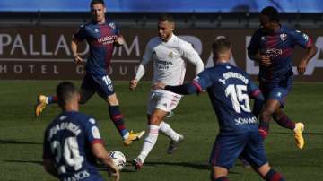 Real Madrid's Eden Hazard, center, runs with the ball next to Huesca defenders during the Spanish La Liga soccer match between Real Madrid and Huesca at Alfredo di Stefano stadium in Madrid, Spain, Saturday, Oct. 31
