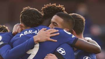 Chelsea players celebrate with Hakim Ziyech, centre right, after he scored his side's opening goal during an English Premier League soccer match between Burnley and Chelsea at the Turf Moor stadium in Burnley, England, Saturday Oct. 31