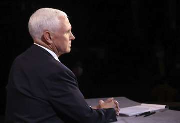 A fly lands on the head of Vice President Mike Pence during the vice presidential debate at Kingsbur