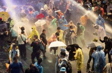 Thailand: Police use water cannon against protesters in Bangkok as PM refuses to quit