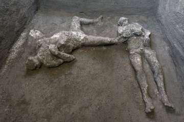 The casts of what are believed to have been a rich man and his male slave fleeing the volcanic eruption of Vesuvius nearly 2,000 years ago, are seen in what was an elegant villa on the outskirts of the ancient Roman city of Pompeii destroyed by the eruption in 79 A.D., where they were discovered during recents excavations, Pompeii archaeological park officials said Saturday, Nov. 21, 2020.