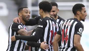 Newcastle's Callum Wilson, left celebrates with team mates after scoring his side's second goal during an English Premier League soccer match between Newcastle United and Everton at the St. James' Park stadium in Newcastle, England, Sunday Nov. 1