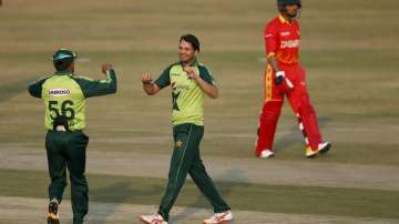 Pakistani spinner Usman Qadir, center, celebrates with teammate Babar Azam after taking the wicket of Zimbabwe's batsman Sikandar Raza, right, during their 2nd Twenty20 cricket match at the Pindi Cricket Stadium, in Rawalpindi, Pakistan, Sunday, Nov. 8